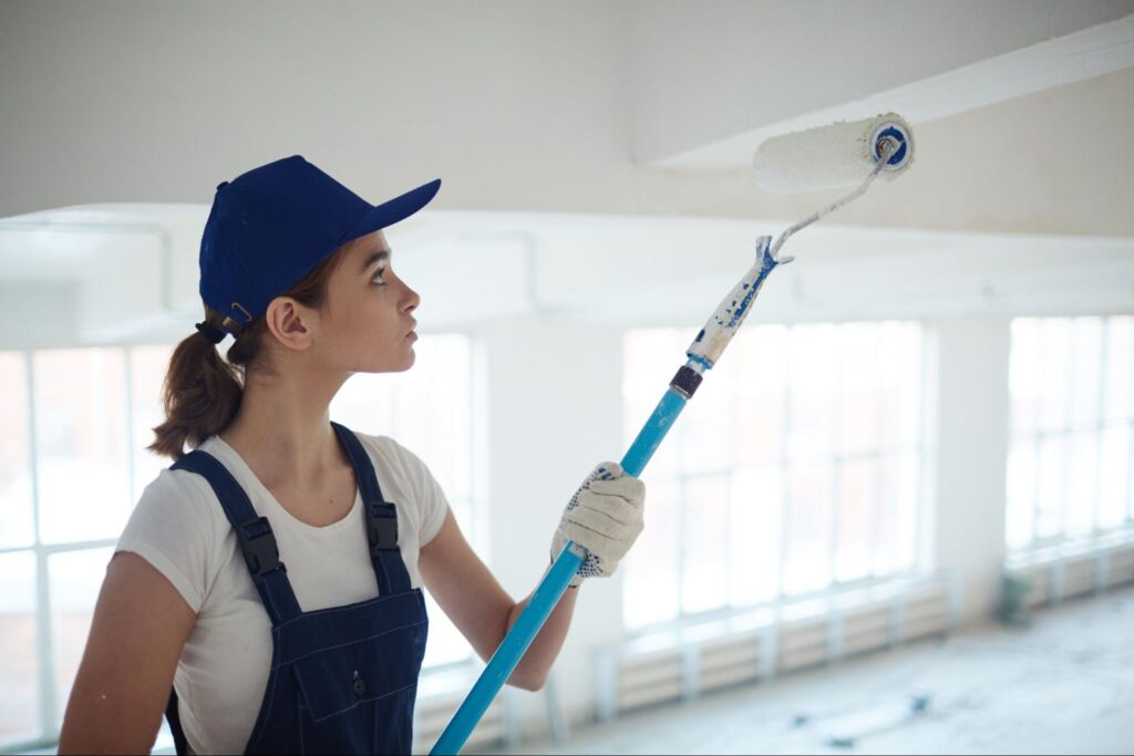 A professional female painter painting the interior ceiling.