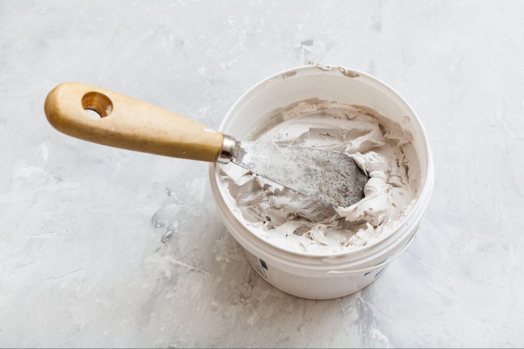 An overview of a bucket with spackle.