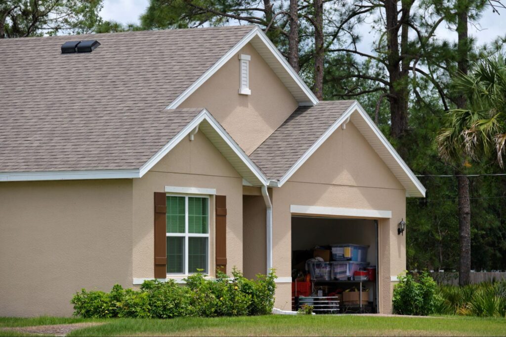 A modern American house exterior painted in warm taupe with white trim showcasing a timeless and versatile neutral color scheme.